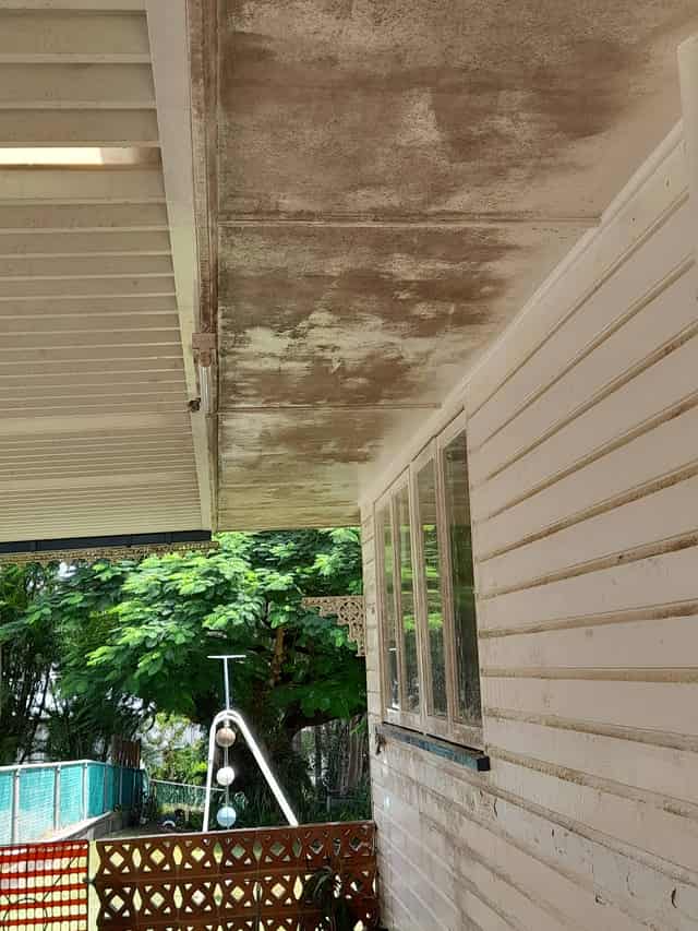 The same home before the wash, with visible mould and grime