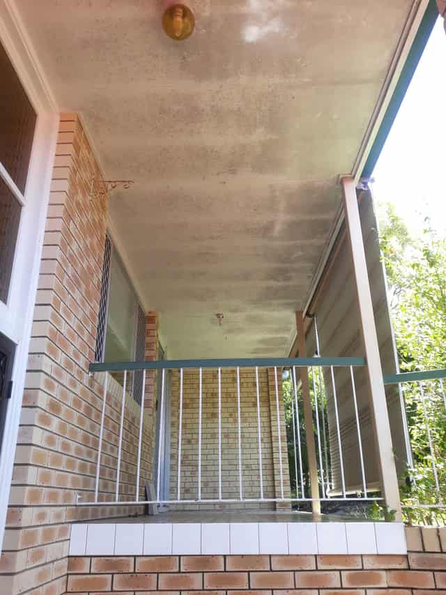 The same home before the wash, with visible mould and grime
