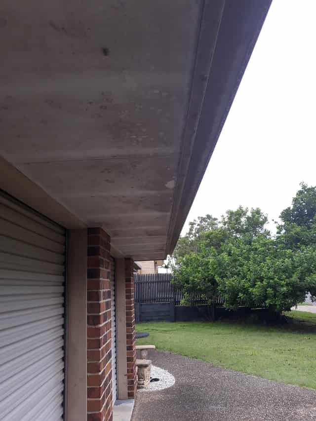 The same home before the wash, with visible mould and grime