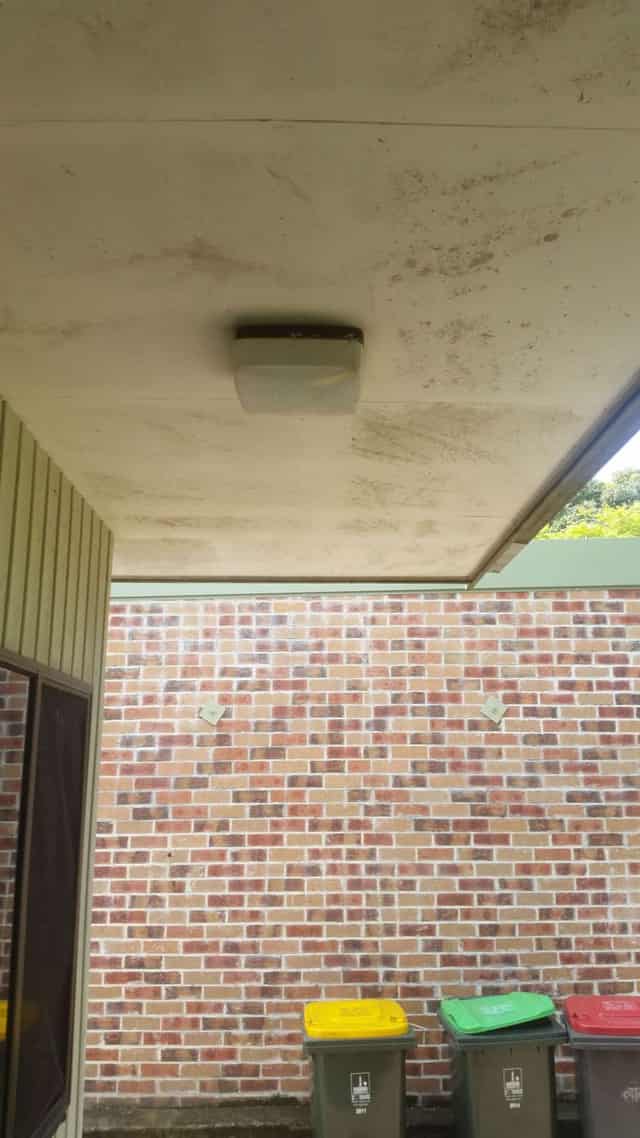 The same home before the wash, with visible mould and grime