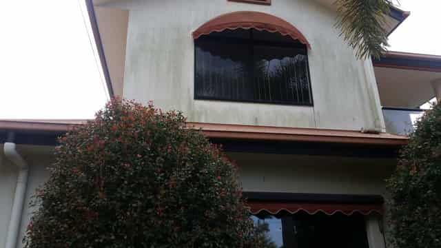 The same home before the wash, with visible mould and grime
